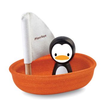 Barca a vela galleggiante con pinguino 